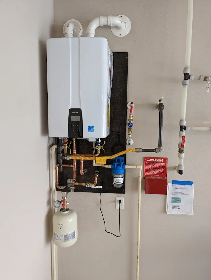 Professional plumber installing copper piping in a Doolittle home